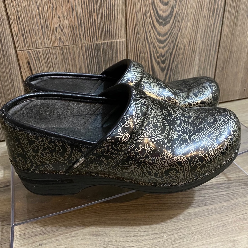 Dansko Black Clog Mules with Metallic Gold Pattern